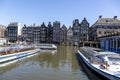 Jetty with pleasure ships on Damrak street in the center of Amsterdam