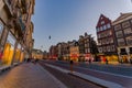 Amsterdam, Netherlands - July 10, 2015: Typical Dutch charming street with red brick houses on both sides