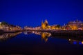 Amsterdam, Netherlands - July 10, 2015: Water channels by night, beautiful dark blue sky and city lights on both sides