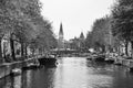 AMSTERDAM, NETHERLANDS. JUNE 06, 2021. Beautiful view of Amsterdam with typical dutch houses, bridges and chanel. Black and white