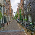 Amsterdam bicycles parked in old cobblestone street Royalty Free Stock Photo