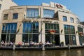 People relax at the Hard Rock cafe at the bank of the Singelgrachtkering Canal in Amsterdam, Netherlands.