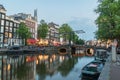 View of Aluminium Bridge over Kloveniersburgwal canal in the evening Royalty Free Stock Photo