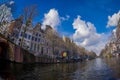 AMSTERDAM, NETHERLANDS, MARCH, 10 2018: Beautiful outdoor view Amsterdam canals with bridge and typical dutch houses