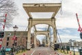 Amsterdam, Netherlands - March 2020: Magere Brug or Skinny Bridge on Amstel river, bascule bridge made of white-painted Royalty Free Stock Photo