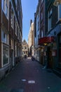 AMSTERDAM, NETHERLANDS - March 20, 2018 : narrow streets of Amsterdam at sunny spring day. Royalty Free Stock Photo