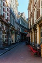 AMSTERDAM, NETHERLANDS - March 20, 2018 : narrow streets of Amsterdam at sunny spring day. Royalty Free Stock Photo