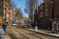 AMSTERDAM, NETHERLANDS - March 20, 2018 : narrow streets of Amsterdam at sunny spring day. Royalty Free Stock Photo