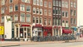 Amsterdam, Netherlands - March 2020 : Amsterdam street panorama with historical buildings, bike parking with many