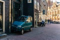 AMSTERDAM, NETHERLANDS - March 20, 2018 : tiny car on narrow street of Amsterdam at sunny spring day. Royalty Free Stock Photo