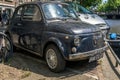 Front of the black old rusty Italian small car Fiat 500L or Lusso