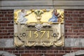 AMSTERDAM, NETHERLANDS - MAY 01, 2018: Ornate plaque on building with date of 1571 Royalty Free Stock Photo