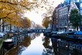 Buildings and house boats along canal during an early autumn fall morning in the Royalty Free Stock Photo