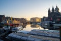 Amsterdam, Netherlands - November 9, 2019: Buildings and house boats along canal during an early autumn fall morning in the Royalty Free Stock Photo