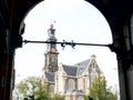 AMSTERDAM, NETHERLANDS-OCTOBER, 12, 2017: close up of westerkerk church framed by an archway in amsterdam