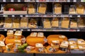 Different types of Dutch cheese wrapped and stacked in a grocery shop in Amsterdam Royalty Free Stock Photo