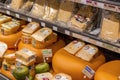 Different types of Dutch cheese wrapped and stacked in a grocery shop in Amsterdam Royalty Free Stock Photo