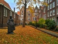 Amsterdam / The Netherlands - October 30 2016: Old yard Begijnhof with houses, garden and a sculpture