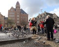 Tourists feed the pigeons in Amsterdam, Holland