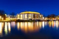 Amsterdam, Netherlands. Opera and Ballet Building. Evening cityscape. Blue sky and city lights. Dutch canals.