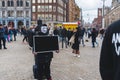 04.18.2023 Amsterdam, Netherlands. Person in anonymous mask holding black screen during protest in Amsterdam. Outdoor