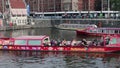 Red open topped canal sight seeing tourism boats maneuvering