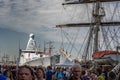 Amsterdam, Netherlands, 08/22/2015: Sail Amsterdam festival. Boats and ships on the canals of the city. Visitors to the show walk