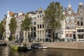 AMSTERDAM, NETHERLANDS - Sep 22, 2020: Amsterdam canal bridges and mansions with trees in autumn sunset Royalty Free Stock Photo