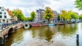 Canal boat entering the Keizersgracht canal from the Leliegracht canal in the old historic center of Amsterdam