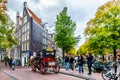 Horse and Carriage carrying tourists in the Jordaan neighborhood of Amsterdam Royalty Free Stock Photo