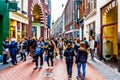 Tourists and locals in the busy Niewendijk shopping street in the historic center of Amsterdam