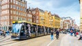 Tourists and a Tram at the busy Dam square in the historic center of Amsterdam Royalty Free Stock Photo