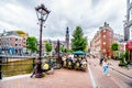 Typical scene of a gathering of tourists and locals at a cafe at the Prinsengracht in Amsterdam