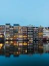 Night view of Amsterdam cityscape with canal, bridge and typical Dutch Houses. Netherlands Royalty Free Stock Photo