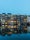 Night view of Amsterdam cityscape with canal, bridge and typical Dutch Houses. Netherlands Royalty Free Stock Photo