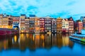 Sunset view of Amsterdam cityscape with canal, bridge and typical Dutch Houses. Amsterdam, Netherlands Royalty Free Stock Photo