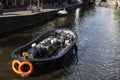 Canal with people sailing in a boat in Amsterdam, Netherlands Royalty Free Stock Photo