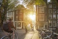 Amsterdam, Netherlands - September 22, 2021: Early morning. People ride bicycles, the ancient European city. Sunlight and silhouet