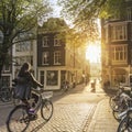 Amsterdam, Netherlands - September 22, 2021: The girl rides a bike. Early morning in Amsterdam. Sunny quiet street of an ancient E Royalty Free Stock Photo