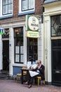Senior man smoking and reading a newspaper in Amsterdam, Netherlands Royalty Free Stock Photo