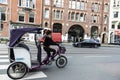 Young woman on rickshaw taxi bike circulating in Amsterdam, Netherlands