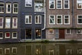 Amsterdam, Netherlands, 10/10/2019: Traditional old houses on the water in the center of a European city. Front view