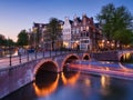 Amsterdam, Netherlands. View of houses and bridges during sunset. The famous Dutch canals and bridges. A cityscape in the evening. Royalty Free Stock Photo