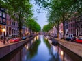 Amsterdam, Netherlands. View of houses and canals during sunset. The famous Dutch canals and bridges. A cityscape in the evening.