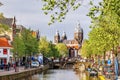 Amsterdam, Netherlands. View of St. Nicholas Church, canal with bridge and typical dutch houses. Royalty Free Stock Photo