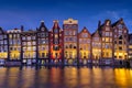 Amsterdam, Netherlands. View of traditional houses during sunset. The famous Dutch canals. A cityscape in the evening. Royalty Free Stock Photo