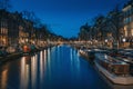 Amsterdam night city skyline at water canal waterfront with boat houses, Amsterdam, Netherlands Royalty Free Stock Photo