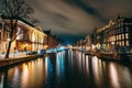 Amsterdam night city water canal with evening lights reflection and old houses, Amsterdam, Netherlands Royalty Free Stock Photo