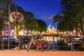 Amsterdam, with flowers and bicycles on the bridges over the canals, Holland, Netherlands. Royalty Free Stock Photo