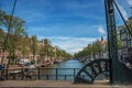 Bicycle at bascule bridge on canal with old buildings and blue sky in Amsterdam. Royalty Free Stock Photo